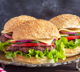 burger with fried cutlet, cheese and vegetables