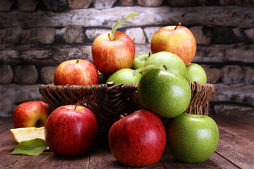 Naklejka na ściany i meble Ripe red apples and green apple on wooden background