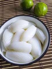 Vietnamese cuisine: white cuttlefish raw on a bamboo background
