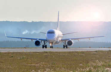 Fototapeta na wymiar Airplane landing on a runway
