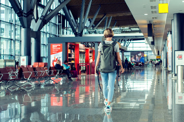 Fototapeta premium Travel concept, people in the airports , young girl with luggage walking at airport