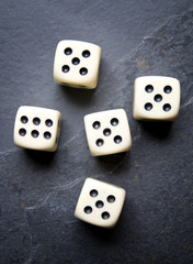 Dice for game on a black background. Four identical bones.