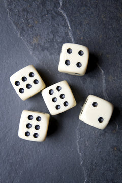 Dice for game on a black background. Three identical bones.