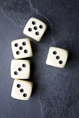 Dice for game on a black background. Full Three and a couple.