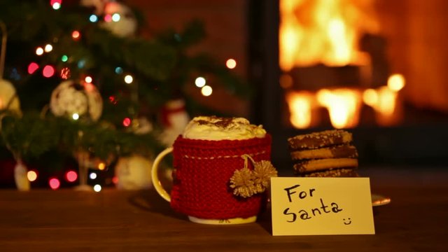 Cookies and hot chocolate prepared for santa - in front of fireplace and christmas tree, cinemagraph