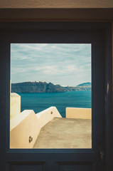 Window with view of Thira and caldera of Santorini volcano