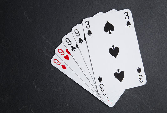 Poker cards on a dark background. Four cards with the same value.
