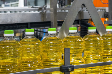 Sunflower oil in the bottle moving on production line