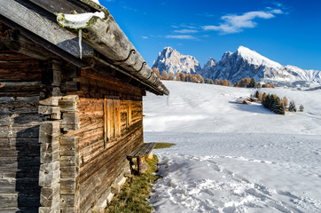 Wooden chalet in the winter in the Dolomites