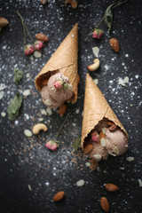 Chocolate ice cream on the tabble with nuts on dark background