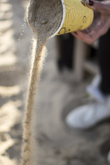 Concept with sand and paper cup on the beach.