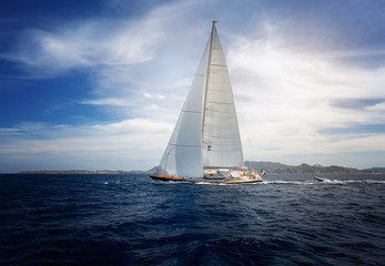 Fototapeta premium Luxury yacht under Italy flag at Sailing regatta. Sailing in the wind through the waves at the Sea.