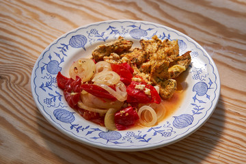 Roasted marinated spiced chicken strips with baked or roasted vegetables, sweet pepper, onion in own juice  served on rustic plate healthy food for reduction weight diet                              