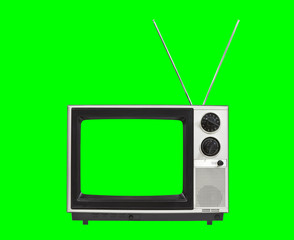 Portable vintage television with antennas and chroma green screen and background.