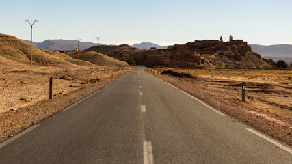 Paved road going through Sahara desert in Morocco