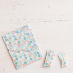 Top view on nicely wrapped Christmas or birthday gifts on white wooden table background. Holiday...