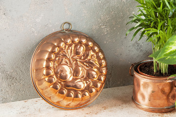 Vintage copper mold on a concrete background.
