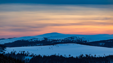 Astonishing sunset colours during a cold winter day in the mountains in Romania