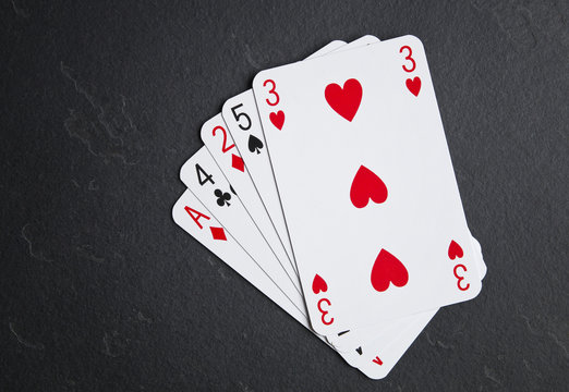 Poker cards on a dark background. High card layout.