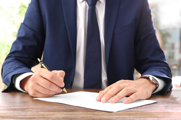 Lawyer working with documents at table, focus on hands