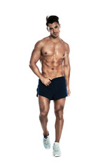 Handsome young man running on white background