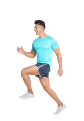 Handsome young man running on white background