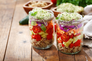 Fototapeta na wymiar Vegetarian food. Healthy salad with quinoa and vegetables in a glass jar