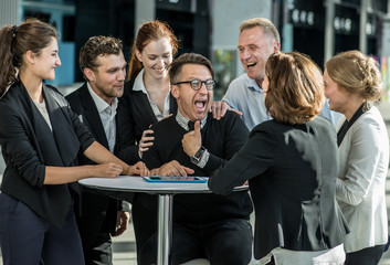 Business people congratulating coworker