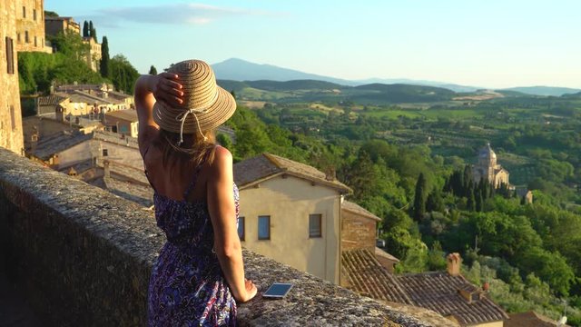 Montepulciano, Tuscany, Italy, Girl looks at the landscape of the city and countryside from the balcony