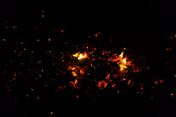 Flame of fire with sparks on a black background