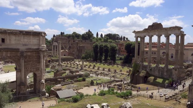 Exterior of ancient ruins Forum Romanum. Unrecognizable people walking through Roman forum in center of Rome, Italy. Historical european architecture. Columns and stones of old monument in slow motion
