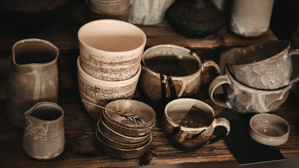 Handmade crafted pottery dishes on the wooden table