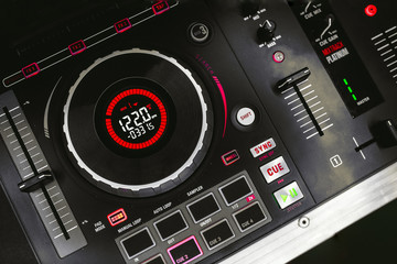  Overhead shot of red party dj audio equipment.Turntable top view.Professional concert DJ top view.High quality mixing controller disc jockey in night club.Pro audio equipment on stage in nightclub © Andrian