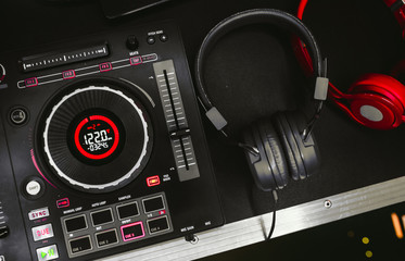 Professional concert DJ red headphones top view.High quality mixing controller for disc jockey in...