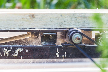Smoothing the wooden bar on an electrical machinery
