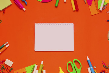School supplies with note on orangeboard