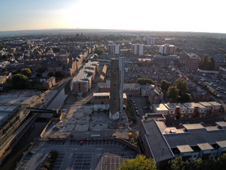 Aerial view, drone panorama of Chester city during golden hour sun close to canal, old shot tower and steam mill area