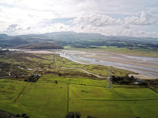 Aerial view, Drone panorama of sea bay during low tide in hilly Wales