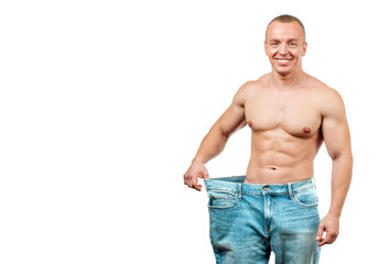 Man wearing big jeans after diet, weight loss