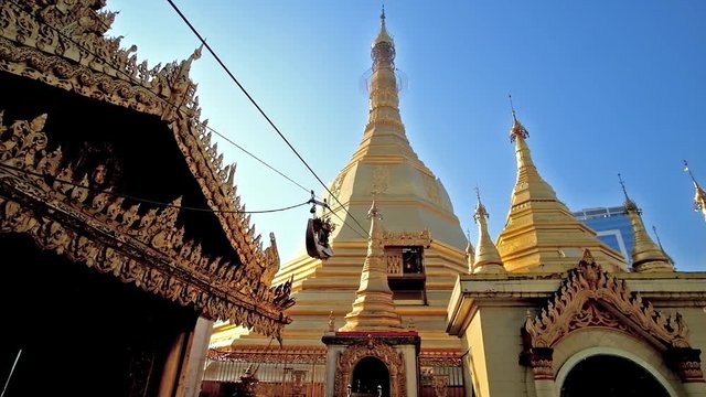 The small cable operating golden boat with sculpture of Karaweik sacred bird delivers the golden leaf offerings to the main stupa of Sule Paya, Yangon, Myanmar. 