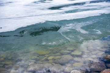 Lake Louise Frozen in Spring. Lake Louise is a hamlet in Banff National Park in the Canadian Rockies, known for its turquoise, glacier-fed lake ringed by high peaks and overlooked by a stately chateau