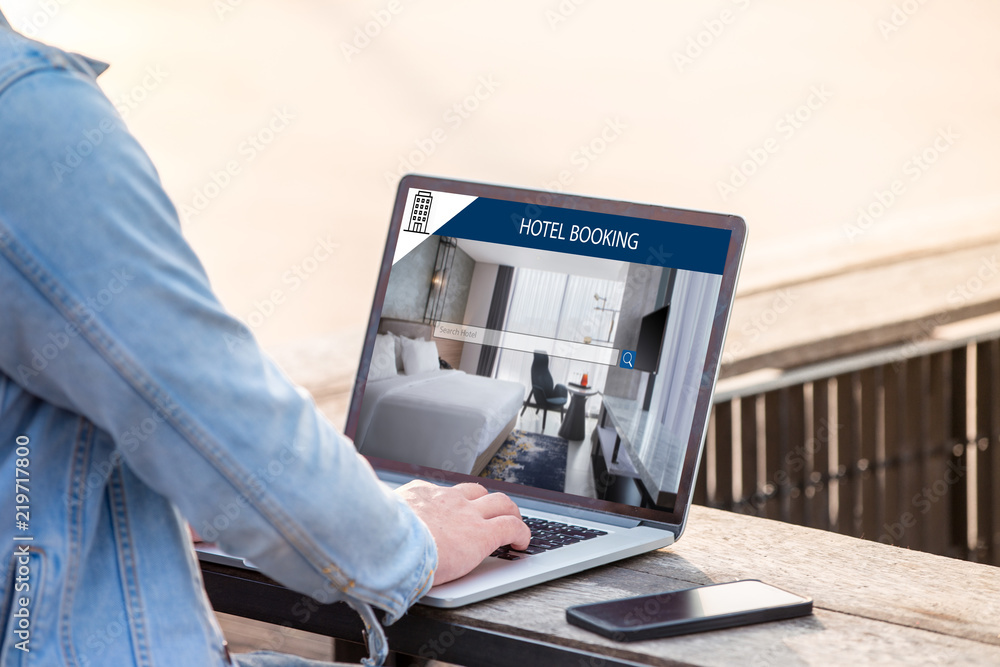 Poster a man is working using laptop, searching for lodging using on-line web service, booking a hotel on w