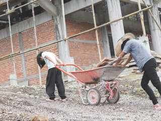 Children working at construction site for world day against child labour concept: