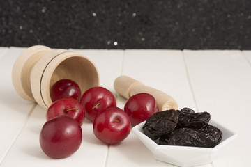 Fresh red plums and dehydrated plums
