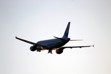 Airplane climbing in the sun