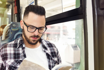 Traveler student studying while riding home by public bus. Concept of commute, public transportation, concentration.