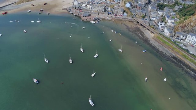 Aerial view, sideways move. Drone panorama over sea, harbor, beach and downtown of Barmouth, Wales