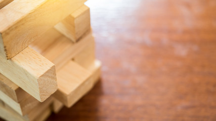 Wooden block game tower on wood background close up