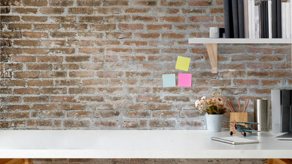 Loft workspace with hipster office supplies. white desk and copy space