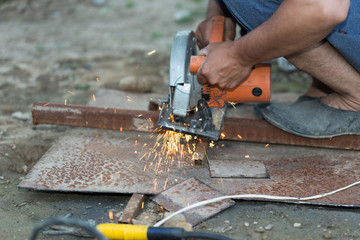 man cut out a sheet of iron, spark on a black background